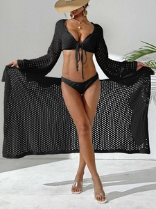 Women's black crochet two-piece beach set with long sleeve tie-up top and wrap skirt