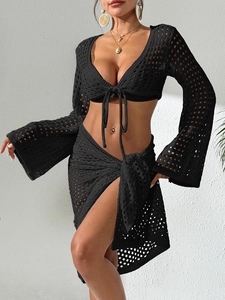 Detail of black crochet knit texture on sexy flare sleeve cardigan and tie-up mini skirt