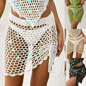 Detail of crochet beach skirt with sequins, drawstring design and hollow knit patterns