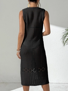 Back view of a black sleeveless crochet hollow out midi beach dress with geometric knit
