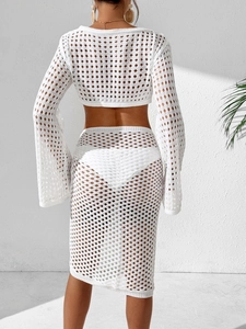 Back view of white crochet beach set with hollow-out knit top and midi skirt detail
