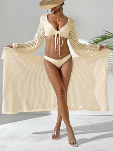 Three-piece beige crochet beach set featuring hollow out lace cardigan and tie-up top