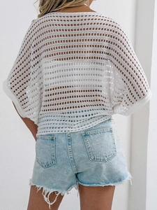 Detailed back view of white hollow-out crochet knit top with loose batwing sleeves