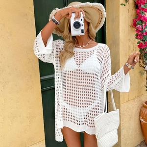 Detail of white crochet waffle knit beach cover-up with hollow geometric patterns
