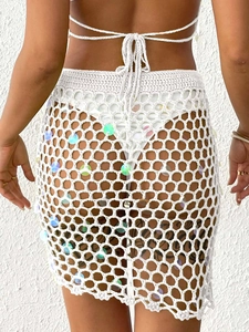 White sequin crochet skirt featuring handmade hollow mesh and asymmetrical hem design
