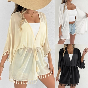 Detail of semi-sheer chiffon beach cover-up with fringe trim and waist tie closure