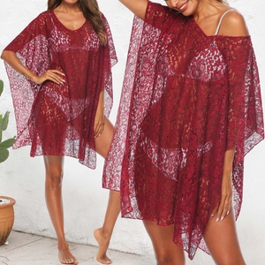 Detail of burgundy lace beach cover-up featuring intricate hollow-out floral patterns