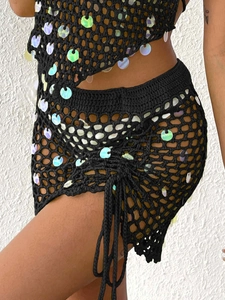 Detail of crochet knit fabric with iridescent sequins and adjustable side drawstring