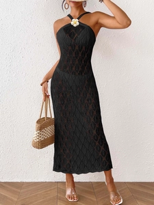 Black knit halter beach maxi dress with hollow leaf pattern and white floral detail