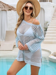 Macro detail of light blue waffle knit beach cover-up with hollow out crochet texture