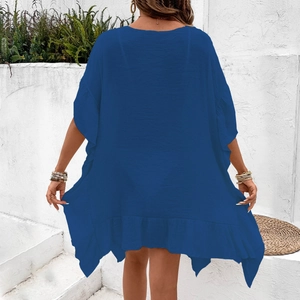 Back view of a flowing royal blue beach cover-up dress with ruffled hem and textured fabric