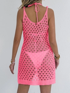 Close-up back view of neon pink crochet hollow out beach cover-up with mesh knit texture