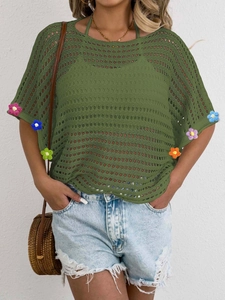 Close-up of crochet hollow knit top with 3D colorful floral cuffs and bohemian details