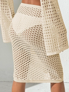 Detail of crochet knit beach skirt set showing intricate hollow patterns and texture