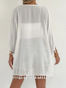 Back view of a white semi-transparent chiffon cover-up with stylish fringe tassels