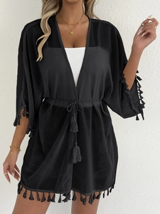 Detail of black chiffon kimono cover-up featuring fringe trim and matching waist tie