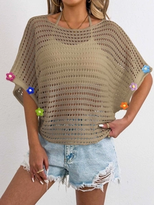 Detail of 3D crochet flowers on khaki hollow knit blouse with batwing sleeves