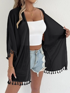 Detail of black chiffon kimono cardigan featuring elegant tassel trim on sleeves and hemline