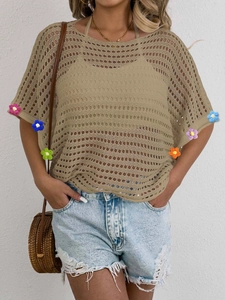 Detail of colorful crochet floral patterns on bohemian hollow-out knit summer top