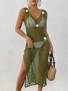 Detail of green crochet dress featuring 3D daisy embroidery and side slit design