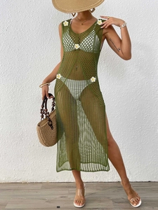 Detail of army green crochet beach dress with white daisy trim and knitted hollow design