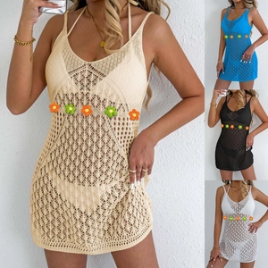 Detailed close-up of hollow out crochet beach cover-up with colorful floral patchwork