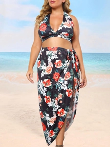 Detail of plus size floral bikini top and matching tie-waist wrap skirt in black and orange
