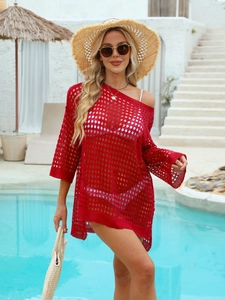 Detailed close-up of red hollow-out waffle knit texture on a long sleeve beach cover-up