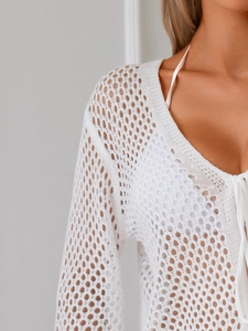 Dettaglio del copricostume bianco all'uncinetto con trama a rombi traforati a maglia
