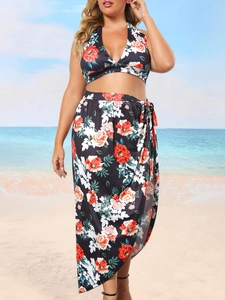 Plus size two-piece floral beach set with halter bikini top and tie-side wrap maxi skirt