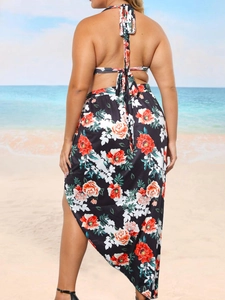 Plus size floral bikini set with high split sarong shown in outdoor beach landscape