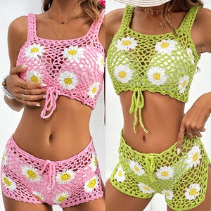 Detail of crochet daisy knit bikini set showing intricate hollow mesh and floral patterns