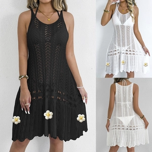 Detailed close-up of crochet hollow-out pattern and floral appliques on the beach cover-up