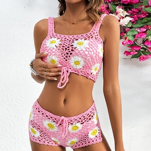 Detail of crochet daisy knit bikini set with pink floral pattern and drawstring shorts