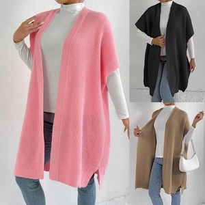 Detailed close-up showing texture of knit vest cardigans in pink, black and brown colors