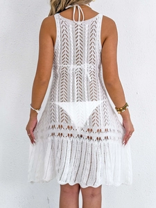 Detailed back view of white crochet lace beach cover-up dress with hollow knit patterns