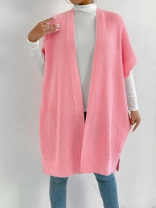 Detailed knit texture of a long pink sleeveless cardigan vest for women in autumn