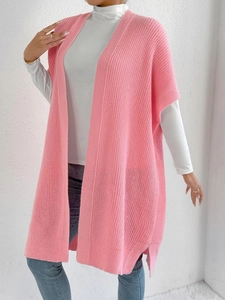 Detail of pink cable knit long sleeveless cardigan vest with side slits texture