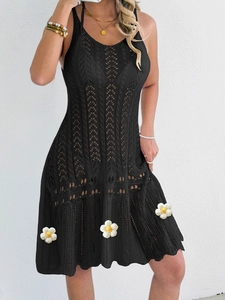 Close-up of black hollow-out crochet knit dress with delicate woven floral textures