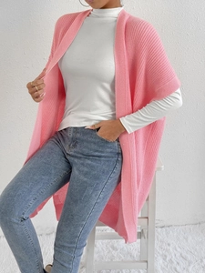 Close-up of pink knit cardigan shawl featuring thick vertical ribbed texture for women