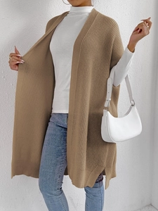 Detail of camel chunky knit vest with side slits and soft wool texture for women