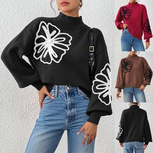 Detailed views of floral embroidery on high-neck lantern sleeve knitted sweater in multi colors