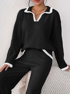 Detail of knit polo sweater and pants set featuring elegant contrast white trim edges