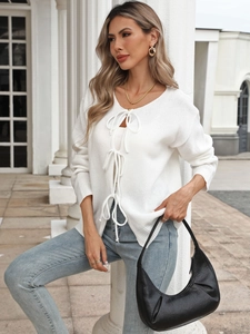 Women's white knit cardigan with bow tie front closure and textured long sleeves