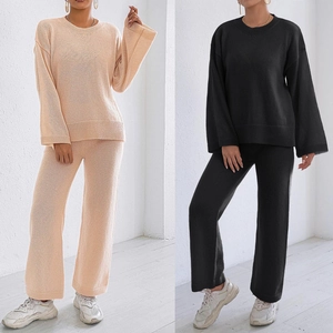 Detail view of knitted lounge set featuring oversized sweater and wide-leg pants in two colors