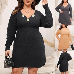 Detail of V-neck knit dress featuring daisy floral embroidery and lace crochet sleeves