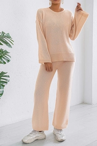 Detail of soft knit texture on cream long sleeve sweater and wide leg lounge pants