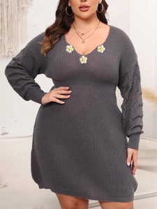 Detail of grey V-neck knit dress with white 3D daisy appliques and hollow sleeve patterns