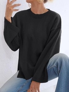Detail eines locker sitzenden Strickpullovers mit Schlagärmeln und Seitenschlitzen in Schwarz