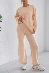Detail of knitted lounge set featuring vertical rib texture and relaxed wide leg trousers